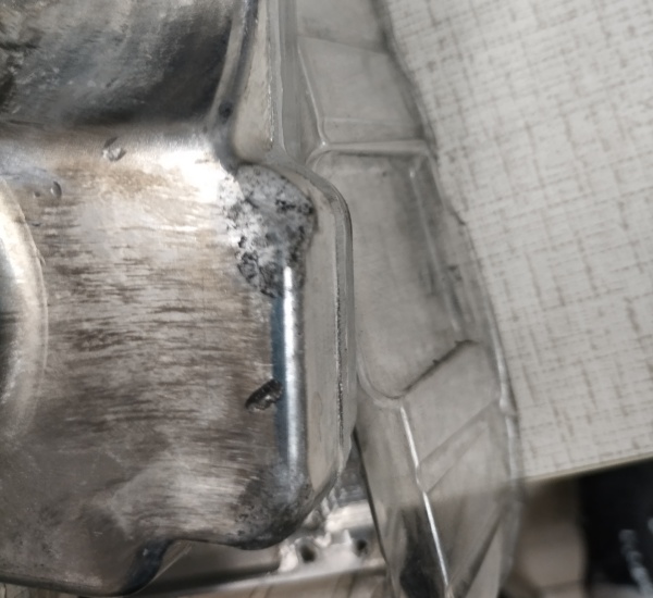 Close-up of carbonization and mold build-up caused by low-quality graphite lubricants at temperatures above 300C.