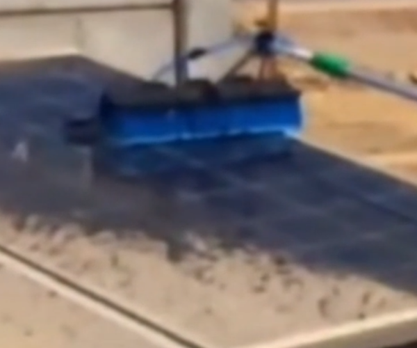 Cleaning solar panels using a professional brush and WG200-H1 neutral pH cleaning solution