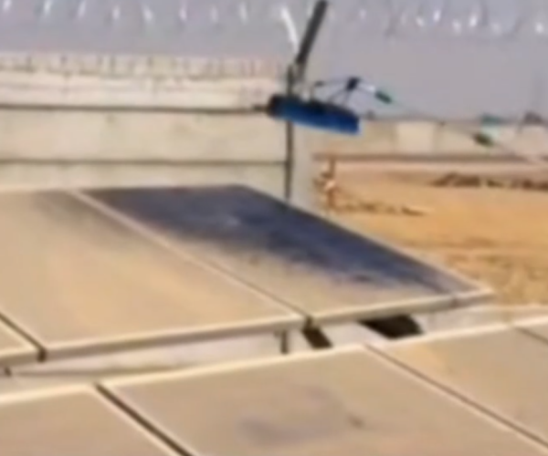 Soiled utility-scale solar panels covered in thick dust before professional O&M cleaning